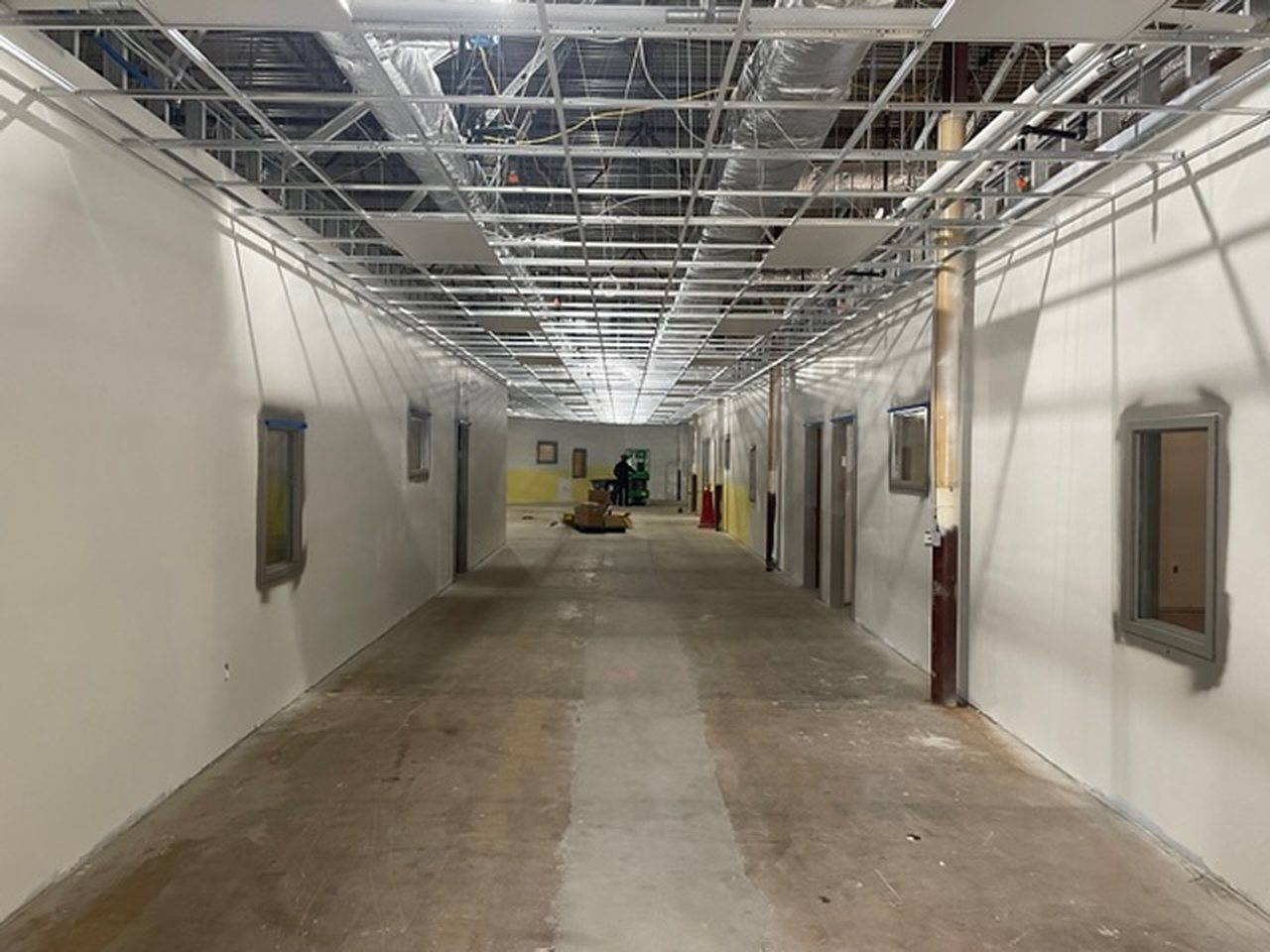 Main corridor during construction, ceiling grid open and slab exposed