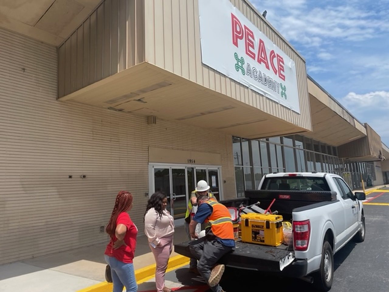 Charter school storefront during construction, signage being installed